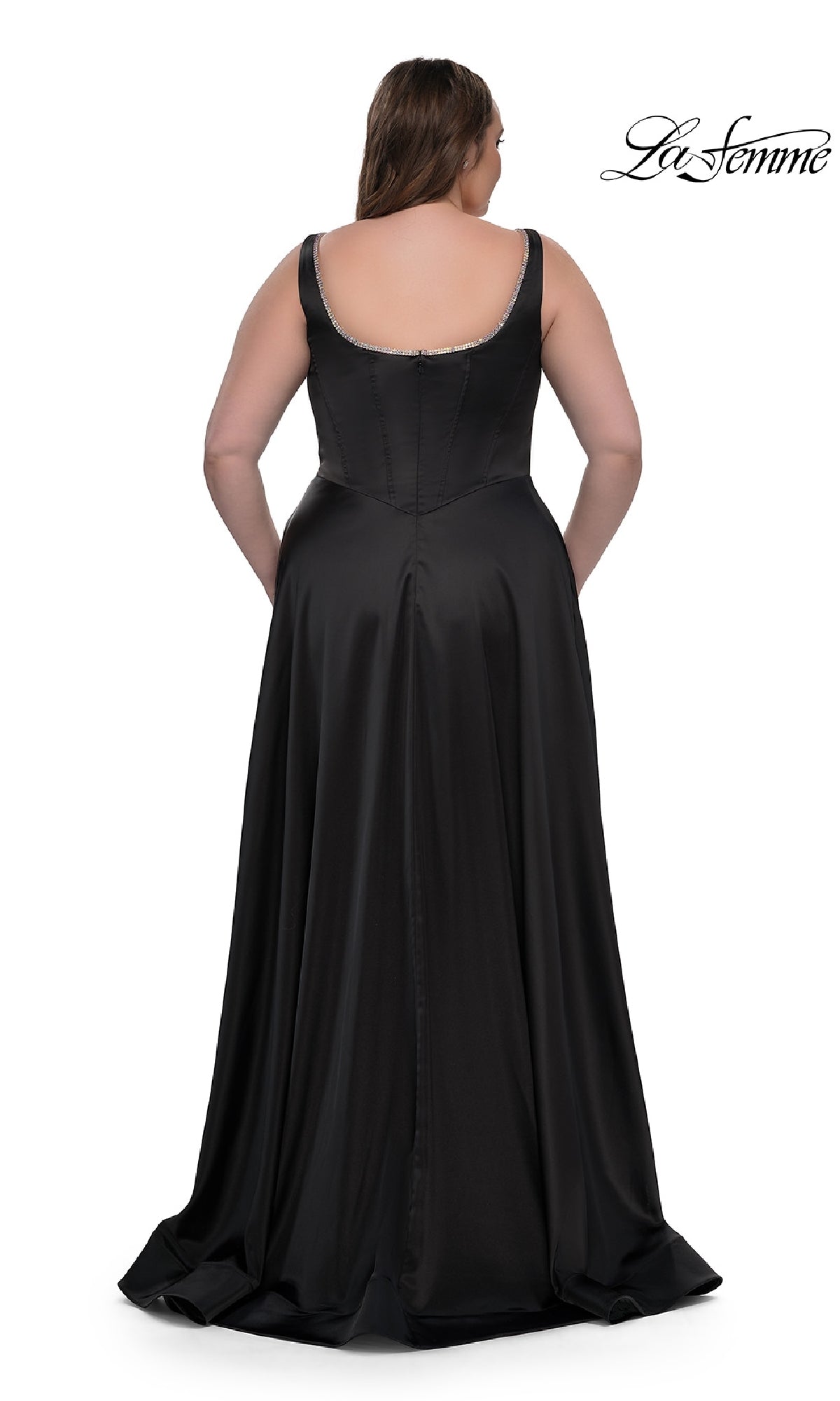 A woman models the Plus-Size Classic Long Prom Gown (La Femme 33026), a sleeveless black satin dress with a scoop back, standing against a white background. The